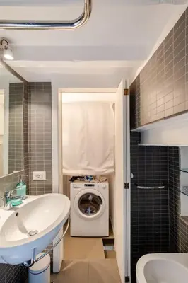 a bathroom with a sink and a washing machine at Maison Campo De Fiori in Rome