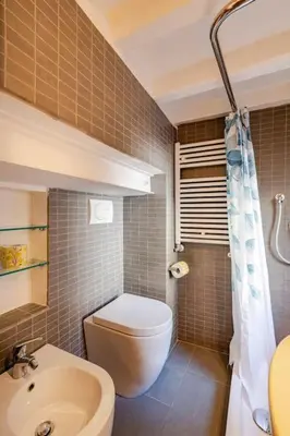 a bathroom with a toilet and a sink at Maison Campo De Fiori in Rome
