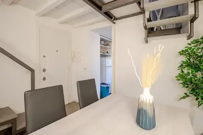 a vase sitting on a table in a room at Maison Campo De Fiori in Rome