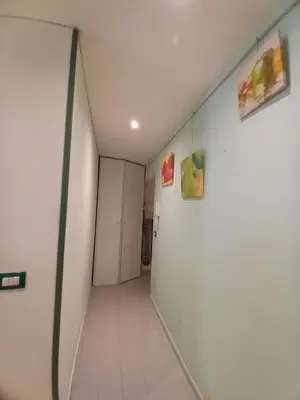 a corridor of a hallway with white walls at Studio Salvia & Rosmarino in Rome