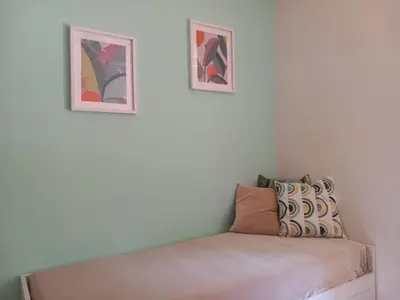 a room with two pictures on the wall and a bed at Studio Salvia & Rosmarino in Rome