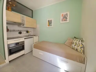 a small kitchen with a bed in a room at Studio Salvia & Rosmarino in Rome