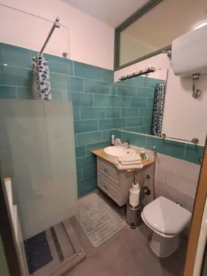 a bathroom with a sink and a toilet and a mirror at Studio Salvia & Rosmarino in Rome