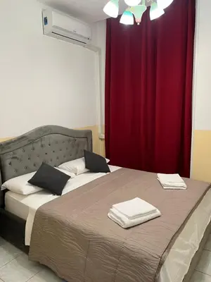 a bedroom with a bed with a red curtain at SALENTINI APPARTAMENTo in Rome