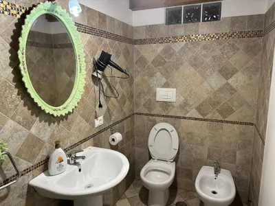 a bathroom with a sink and a toilet and a mirror at SALENTINI APPARTAMENTo in Rome