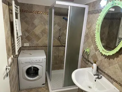 a bathroom with a washing machine and a sink at SALENTINI APPARTAMENTo in Rome