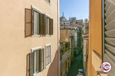 a view of an alley between two buildings with windows at C M Fori Imperiali Apartment in Rome