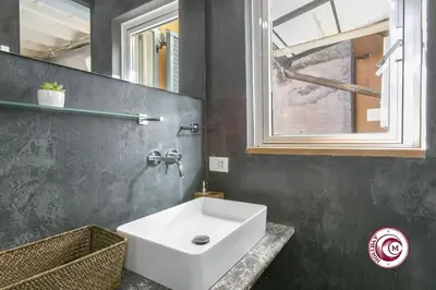a bathroom with a white sink and a window at C M Fori Imperiali Apartment in Rome