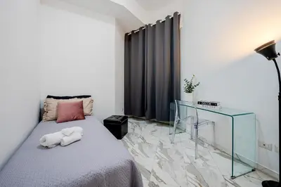 a bedroom with a bed and a glass table at Guinera Guest House in Rome