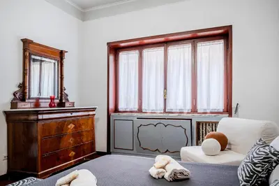 a living room with a chair and a dresser at Guinera Guest House in Rome