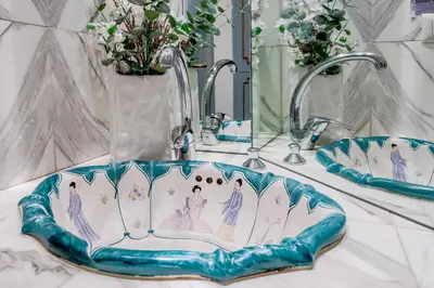 a bathroom sink with a mermaid design on it at Guinera Guest House in Rome