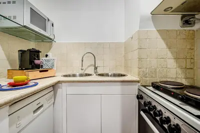 a kitchen with a sink and a stove at Guinera Guest House in Rome