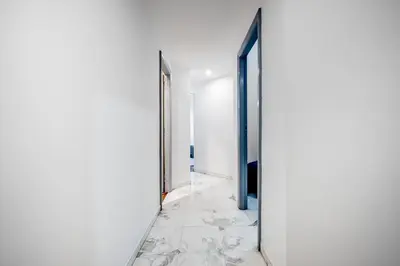 an empty hallway with an open door and marble floors at Guinera Guest House in Rome