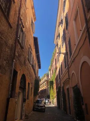 a car parked on a street between two buildings at RHOMENJOY Open Space Colosseo in Rome