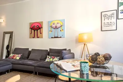 a living room with a couch and a glass table at Sant'Angelo Terrace Apartment in Rome