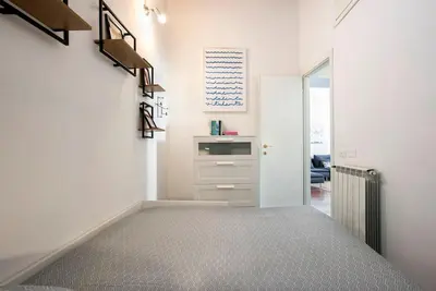 a room with a hallway with a bed and a staircase at Sant'Angelo Terrace Apartment in Rome