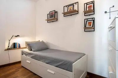 a bed in a room with pictures on the wall at Sant'Angelo Terrace Apartment in Rome
