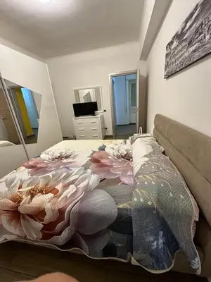 a bedroom with a bed with a flower blanket at Roma nel Mondo in Rome