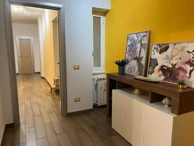 a hallway with yellow walls and a wooden floor at Roma nel Mondo in Rome