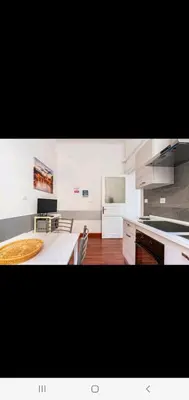 a kitchen with a table and a counter top at Cuore Di Roma Holidays in Rome