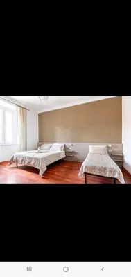 a room with two beds and a window at Cuore Di Roma Holidays in Rome
