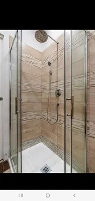 a shower with a glass enclosure in a bathroom at Cuore Di Roma Holidays in Rome