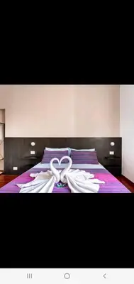 a bed with two white towels on top of it at Cuore Di Roma Holidays in Rome