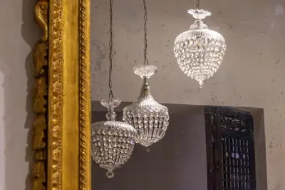 three chandeliers are hanging in front of a mirror at iFlat Pantheon Elegant 3-bedroom Apartment in Rome