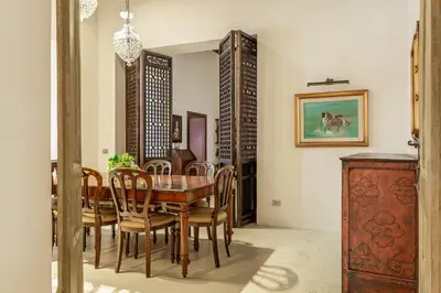 a dining room with a wooden table and chairs at iFlat Pantheon Elegant 3-bedroom Apartment in Rome