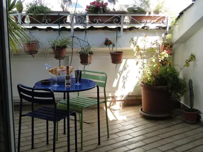 a table and chairs on a patio with potted plants at Jazz Style Home in Rome