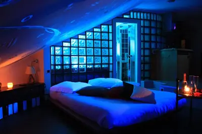 a bedroom with a bed with blue lights on it at Jazz Style Home in Rome