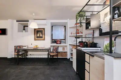 a kitchen with a table in the middle of a room at Casa Calligarich Stadio Olimpico Foro Italico in Rome