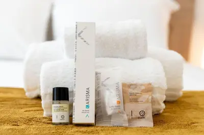 two products are sitting on a table with towels at Metro A 1 min - Casa Elegante - 3 bagni En Suite in Rome