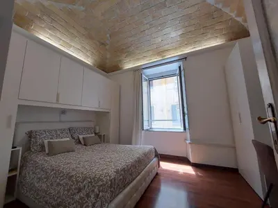 a bedroom with a bed with a wooden ceiling at Nel cuore del Vaticano spazioso ed elegante in Rome