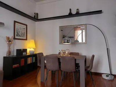 a dining room with a table and chairs and a mirror at Nel cuore del Vaticano spazioso ed elegante in Rome