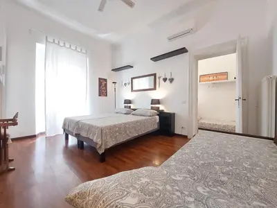 a bedroom with two beds and a window at Nel cuore del Vaticano spazioso ed elegante in Rome
