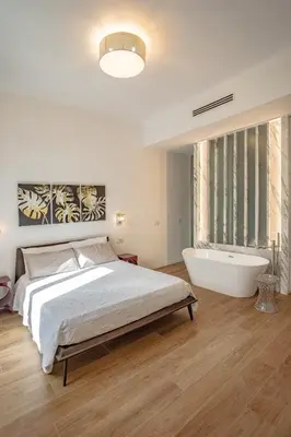 a bedroom with a large bed and a bath tub at a casa di Manuela luxury apartment in Rome