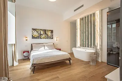a bedroom with a bed and a bath tub at a casa di Manuela luxury apartment in Rome