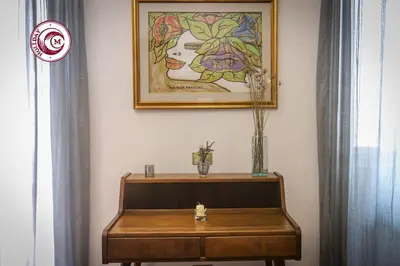 a bench in a room with a painting on the wall at C M La Terrasse di Monti in Rome