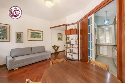 a living room with a table and a couch at C M La Terrasse di Monti in Rome