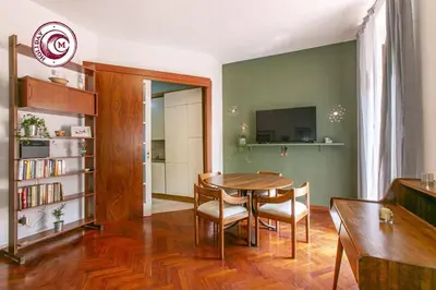 a dining room with a wooden table and chairs at C M La Terrasse di Monti in Rome