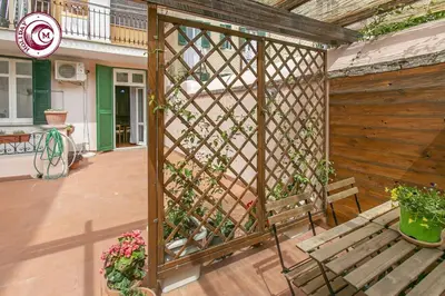 a wooden pergola with a bench on a patio at C M La Terrasse di Monti in Rome