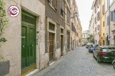 a street with a green door on a building at C M La Terrasse di Monti in Rome
