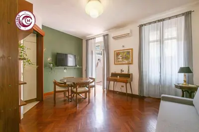 a living room with a table and a dining room at C M La Terrasse di Monti in Rome