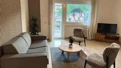a living room with a couch and chairs and a tv at Presidential Vatican Palace II in Rome