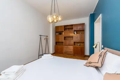 a bedroom with a large white bed and a blue wall at Presidential Vatican Palace II in Rome
