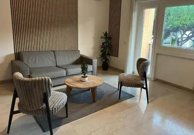a living room with a couch and chairs and a table at Presidential Vatican Palace II in Rome