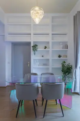 a dining room with a glass table and chairs at Vittoria Urban Chic - elegant apartment in the heart of Rome in Rome