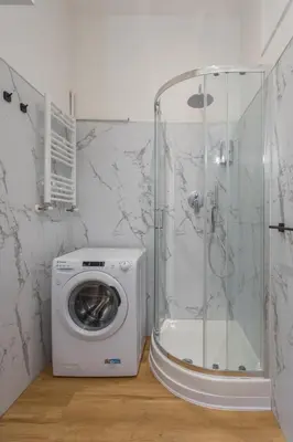 a washing machine in a bathroom with a shower at Vittoria Urban Chic - elegant apartment in the heart of Rome in Rome