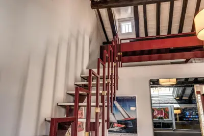 a spiral staircase in a room with a window at Domus in Via Del Corso in Rome